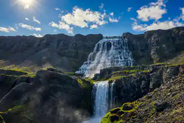 Dynjandi falling in wide white steps down the mountainside