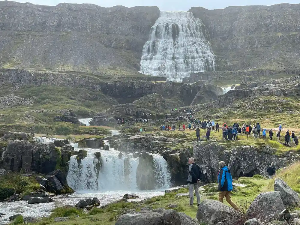 The lower falls and the crowd on the path with Dynjandi behind