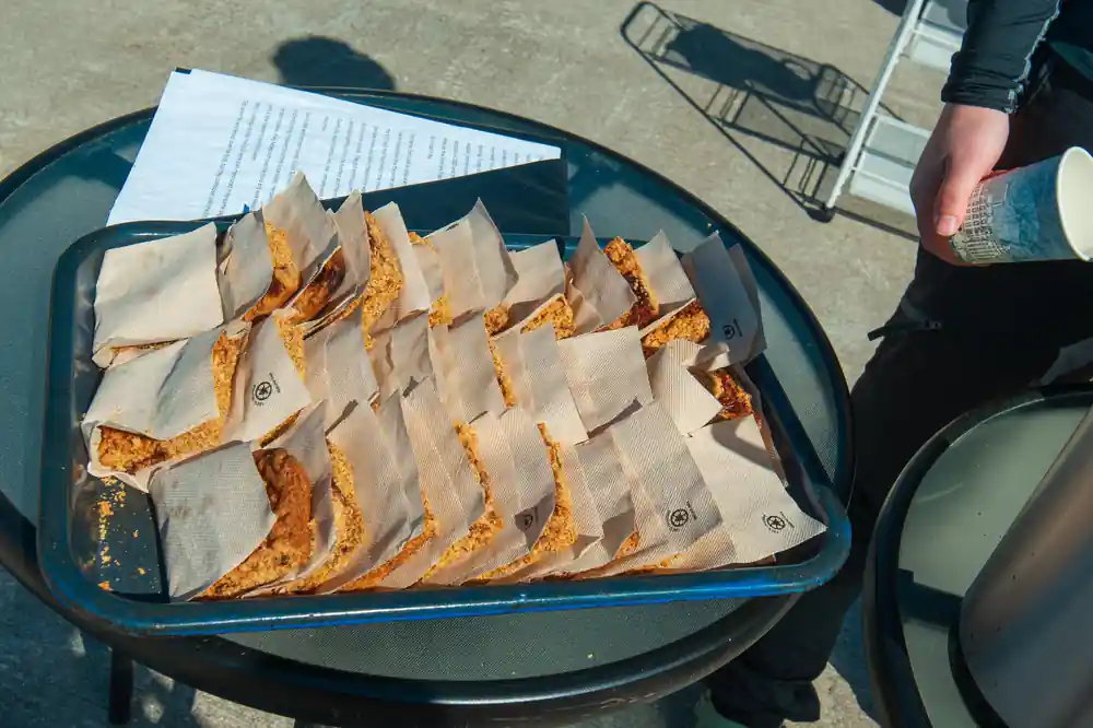 Paper bags of cake laid out on a tray at the coffee stop